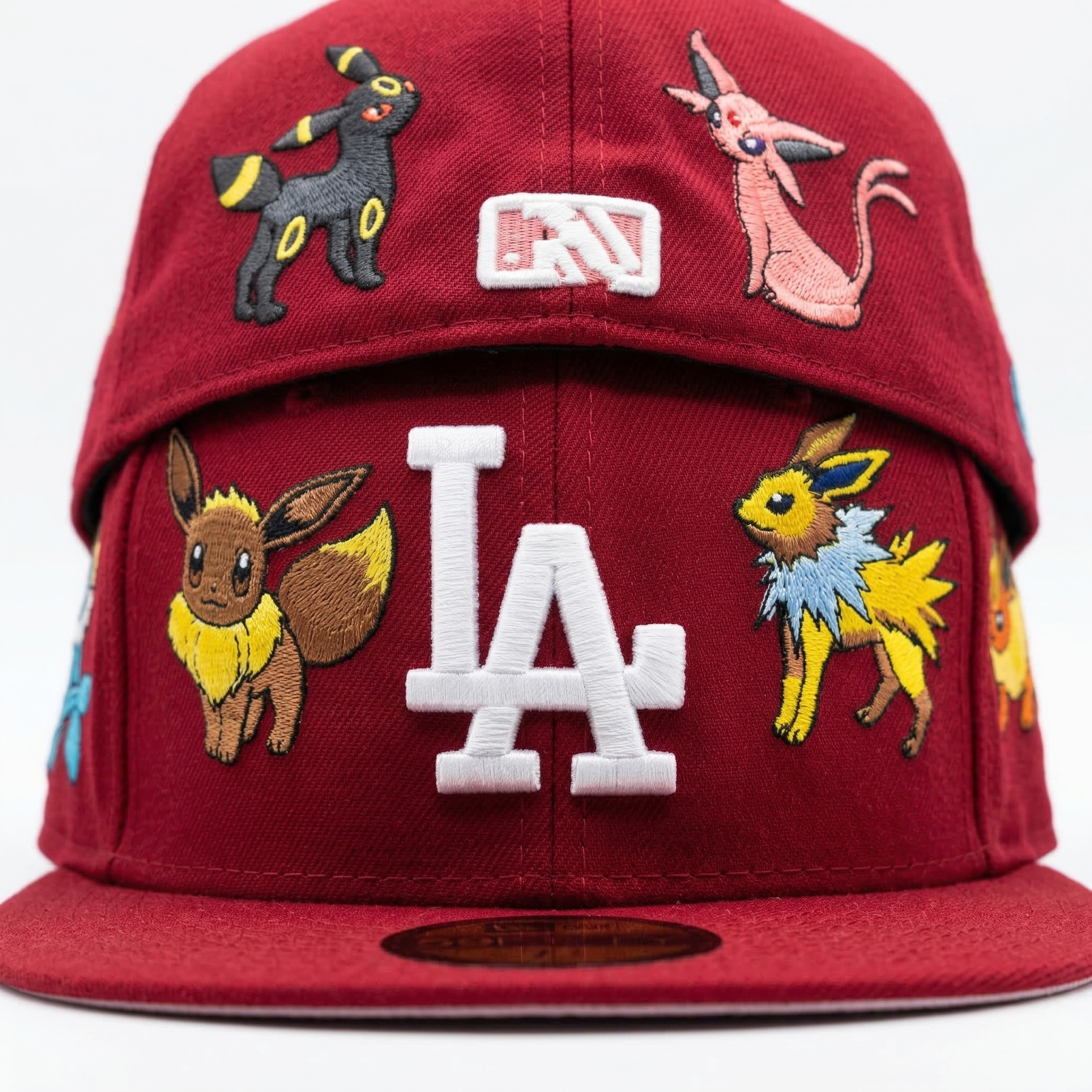 Front detail of custom maroon LA Dodgers hat featuring embroidered Eevee, Jolteon, Umbreon, and Espeon Pokemon patches.