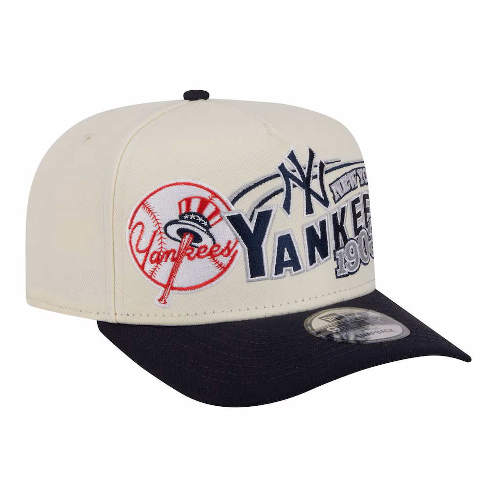 Front angle view of the New Era New York Yankees Classic A-Frame 9FIFTY Snapback Hat in cream and navy, featuring intricate retro team embroidery.