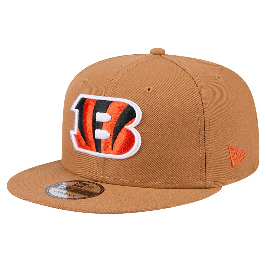 Left angled view of the tan Cincinnati Bengals snapback hat showing the embroidered orange New Era flag logo on the side.