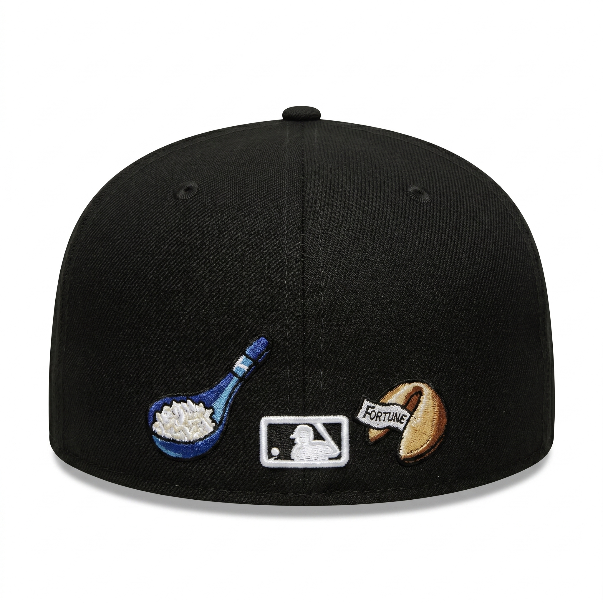 Back view of the custom New York Yankees 59FIFTY hat showing the embroidered MLB Batterman logo between a blue rice spoon and a fortune cookie patch.