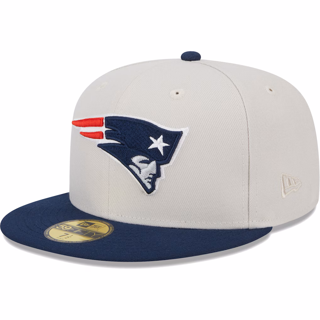 Front-left angled view of the New Era New England Patriots 59FIFTY fitted hat, featuring an off-white crown, navy blue visor, and the Patriots logo.