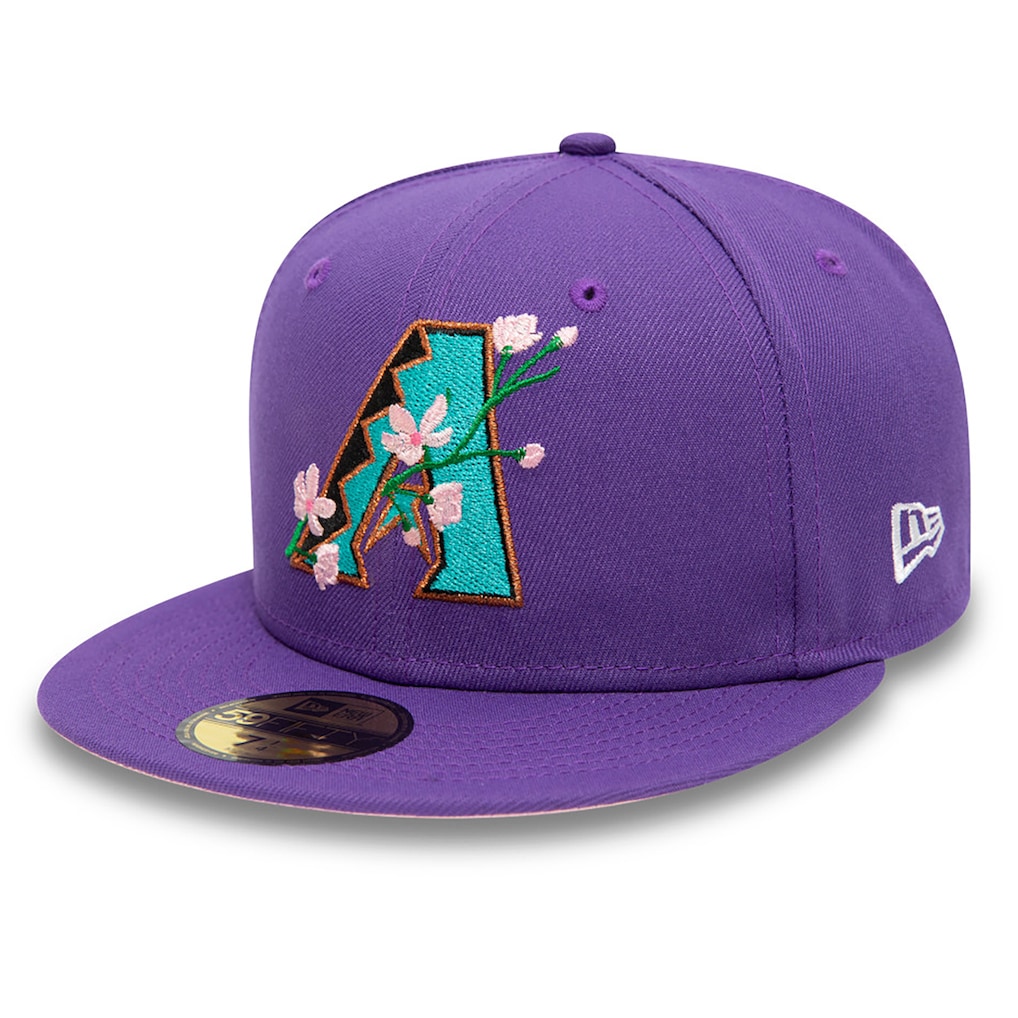 Side view of the purple Arizona Diamondbacks fitted hat displaying the embroidered pink and white 2001 World Series commemorative patch.