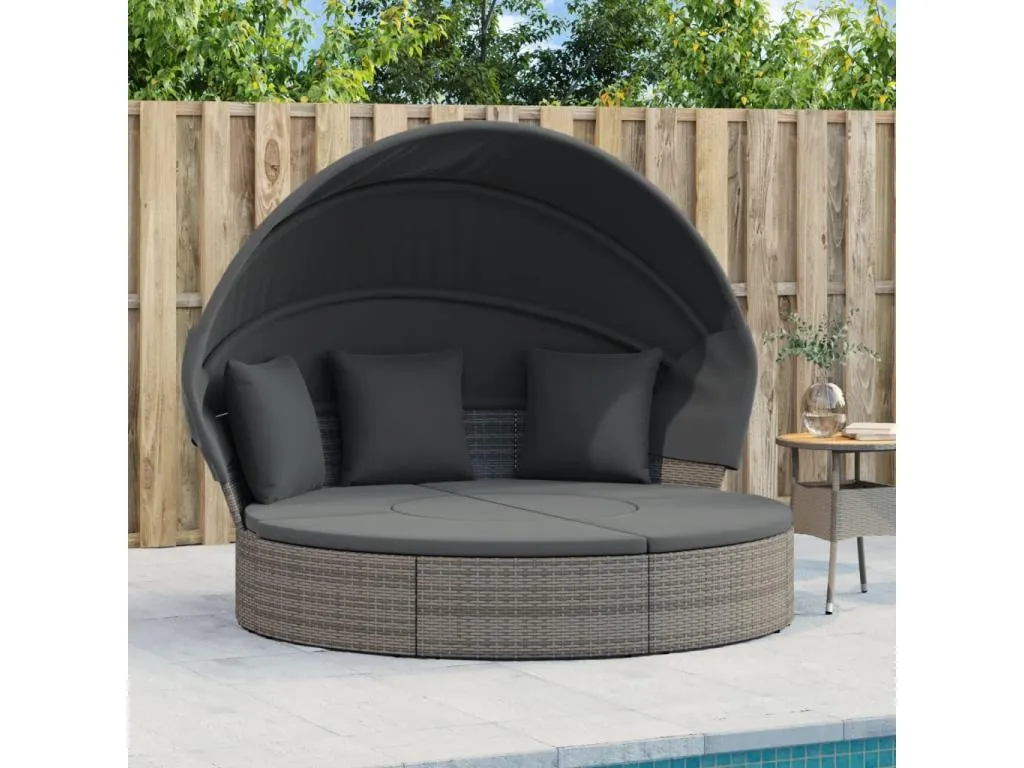 Sofá cama de exterior con dosel y cojines de resina tejida.