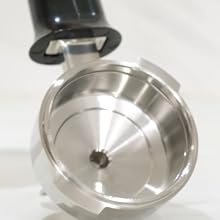 The polished steel commercial portafilter retains heat and is free from blemishes.