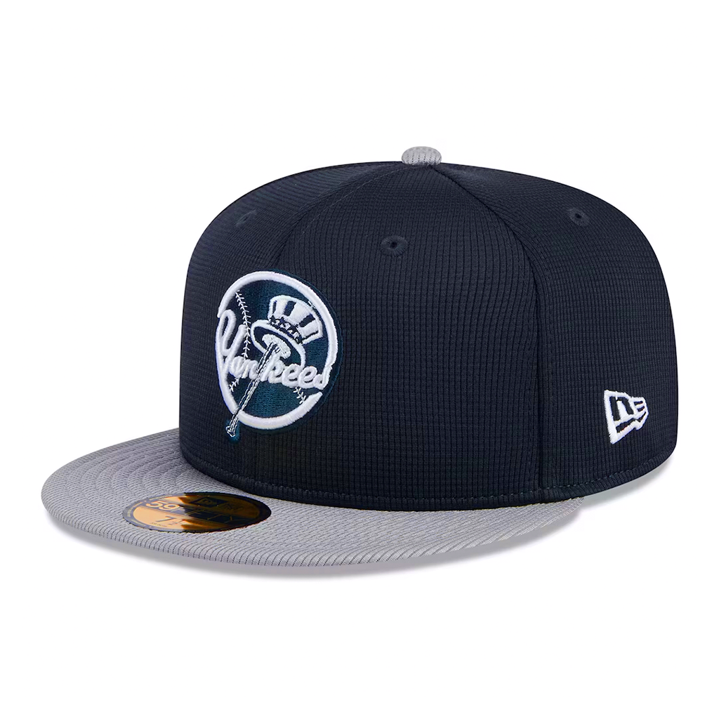 New Era New York Yankees 59FIFTY fitted hat in textured navy blue with a grey visor, featuring the primary top hat logo on the front and the New Era flag on the left side.