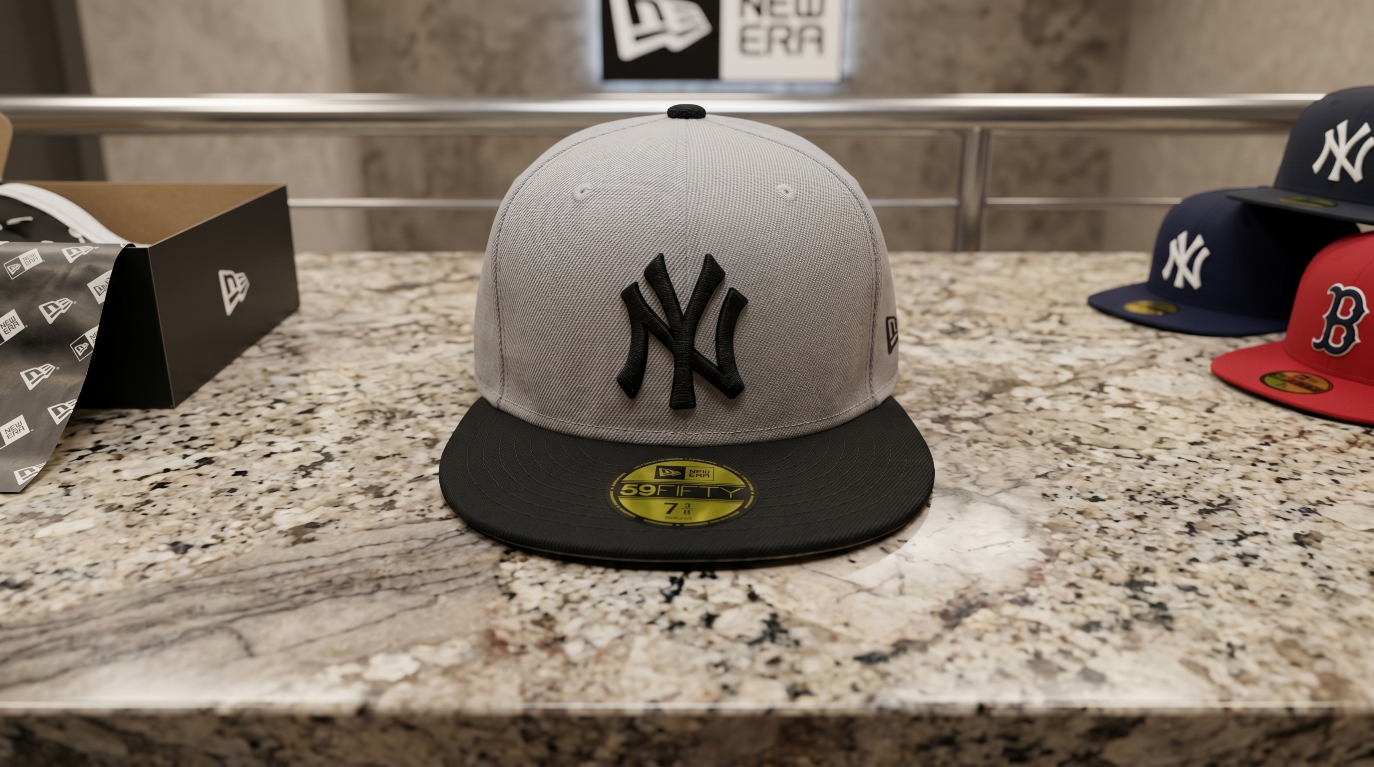 Gray New York Yankees New Era 59FIFTY fitted cap with a black brim resting on a countertop.