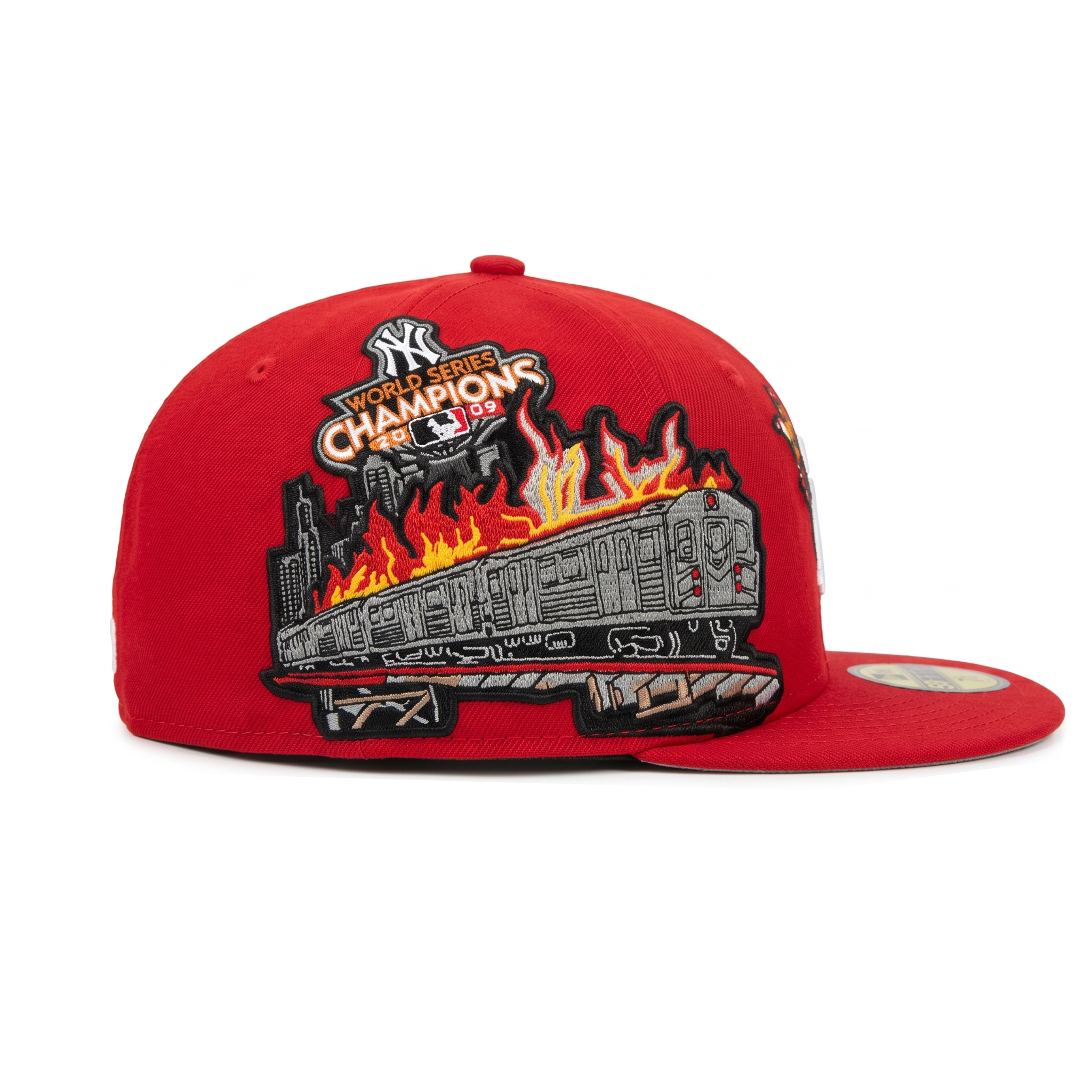 Right profile of custom red NY hat showing a flaming NYC subway train and World Series Champions patch.