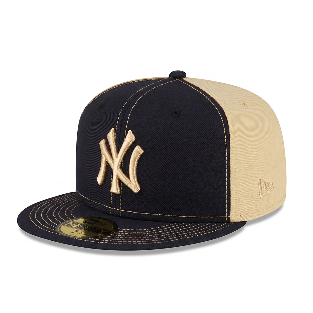 Front angle view of a New Era New York Yankees 59FIFTY fitted hat featuring a navy blue front, khaki back panels, gold contrast stitching, and a raised gold NY logo.