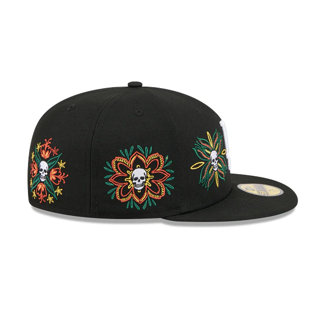 Right side view of the black Los Angeles Dodgers fitted hat showing the wrap-around floral skull embroidery.