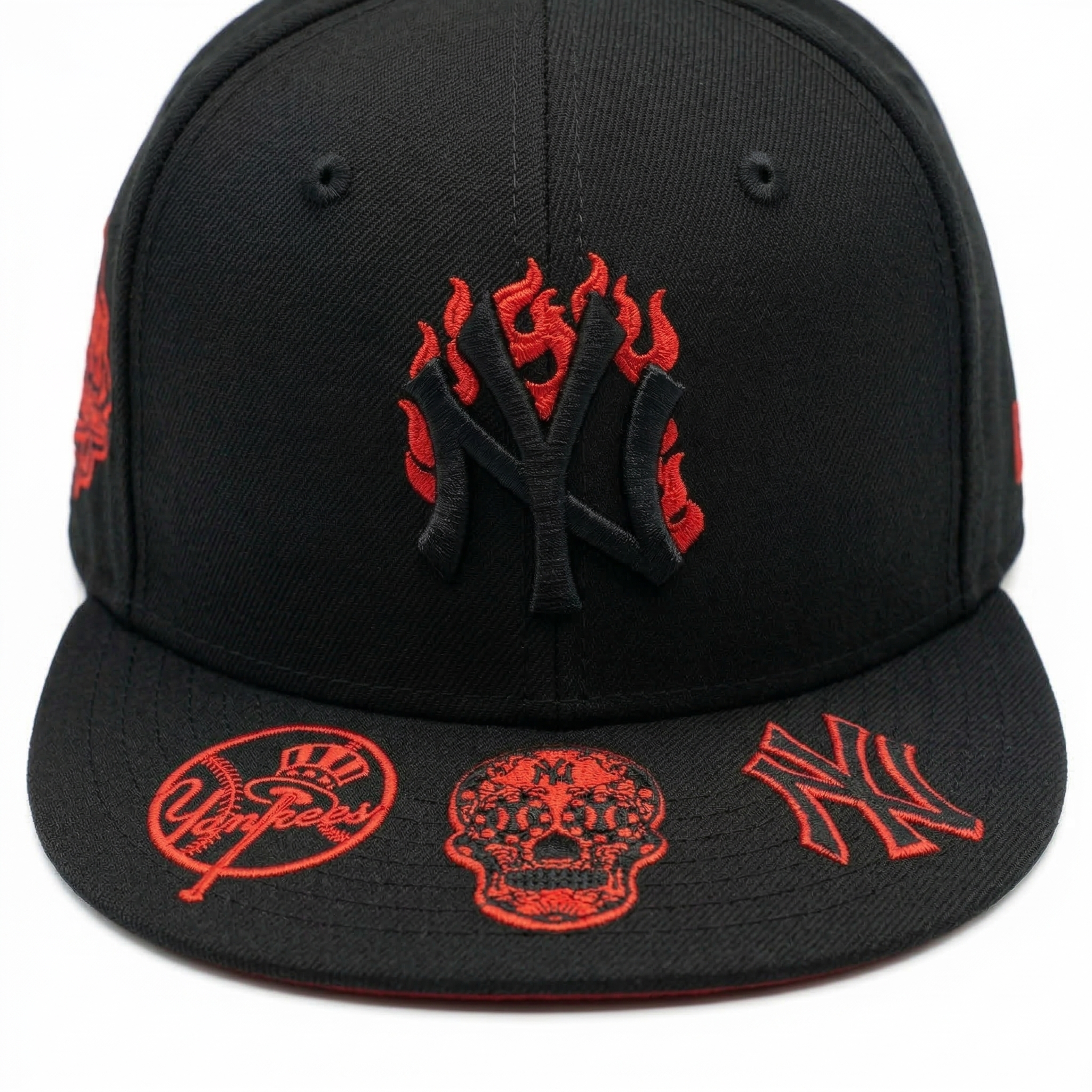 Front view of black NY baseball cap, highlighting red flame logo embroidery and red skull patches on the brim.