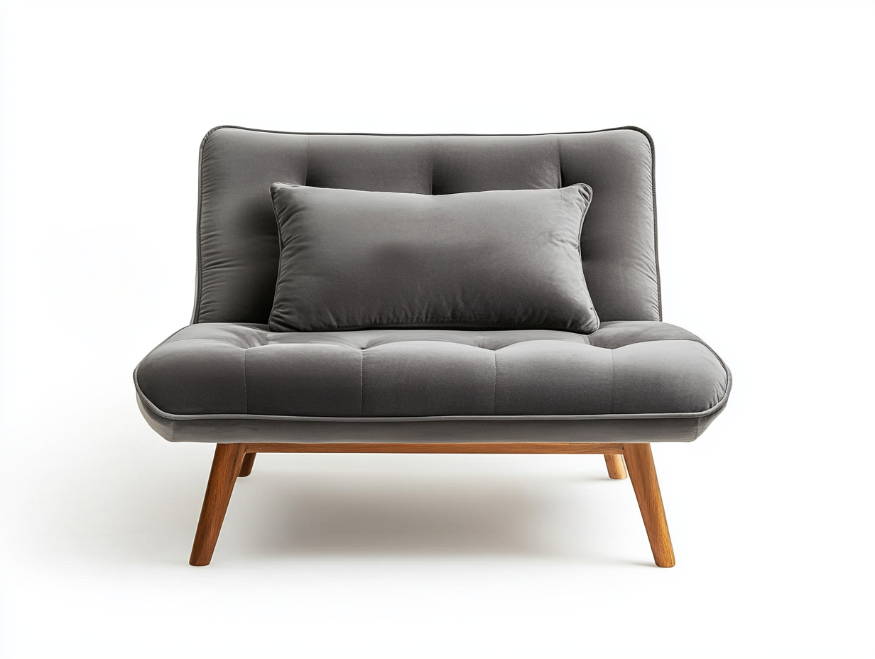 Sillón moderno tapizado en terciopelo gris con patas de madera y cojín decorativo