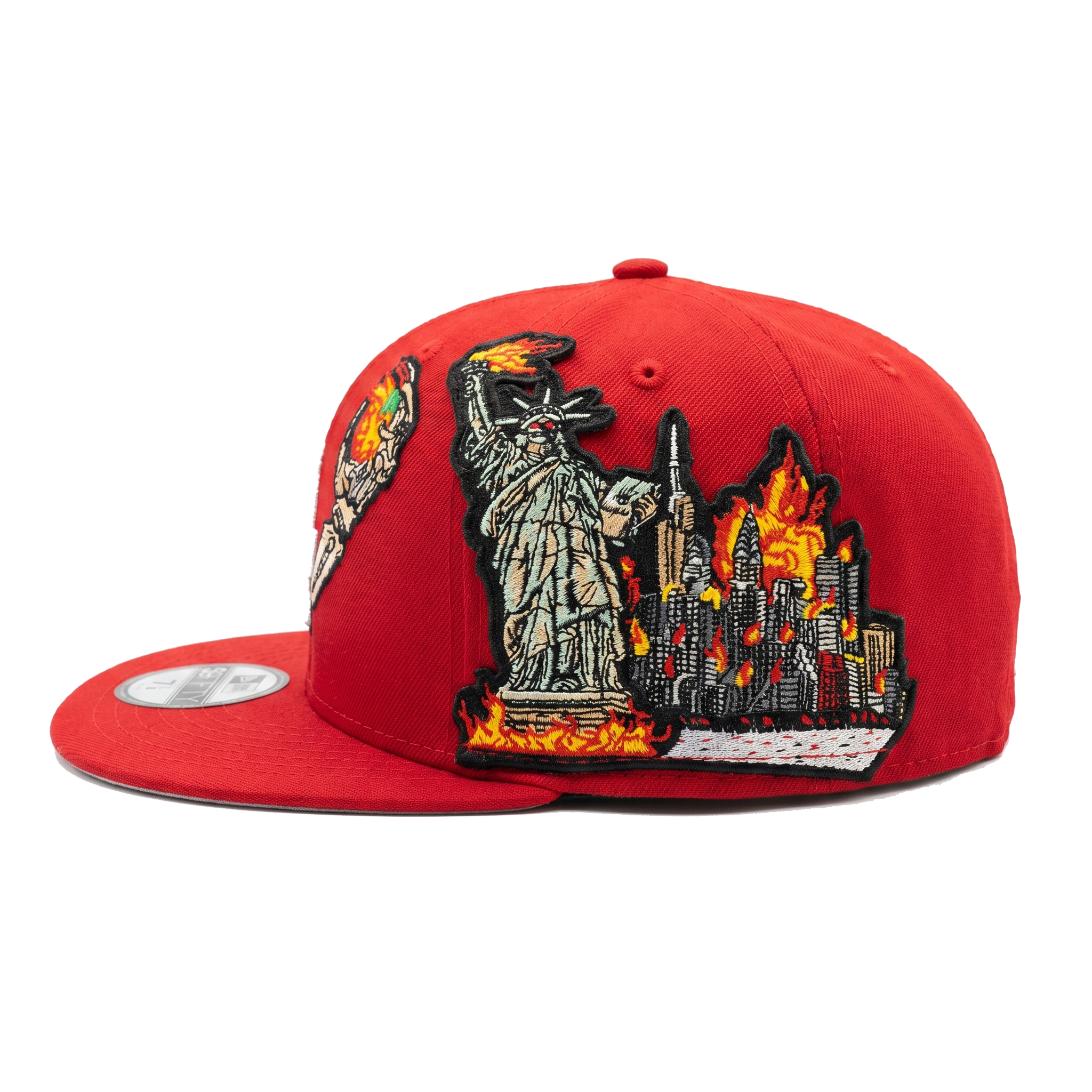 Left profile of custom red NY Yankees hat featuring Statue of Liberty and burning city skyline embroidery.
